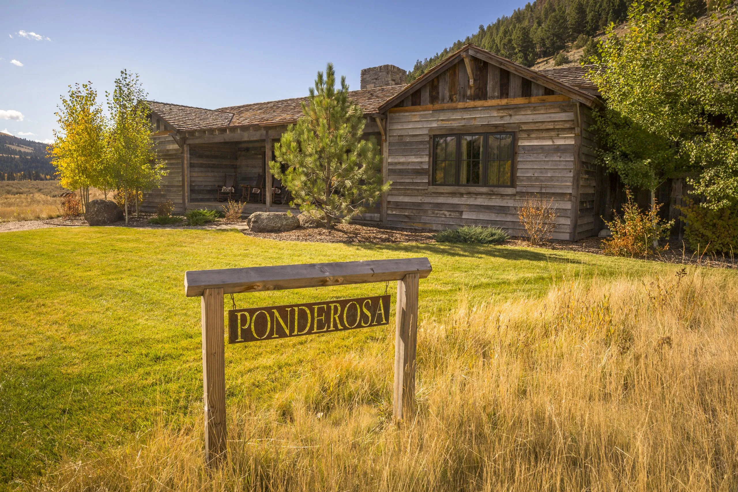 A cabin with a sign that reads "Ponderosa"
