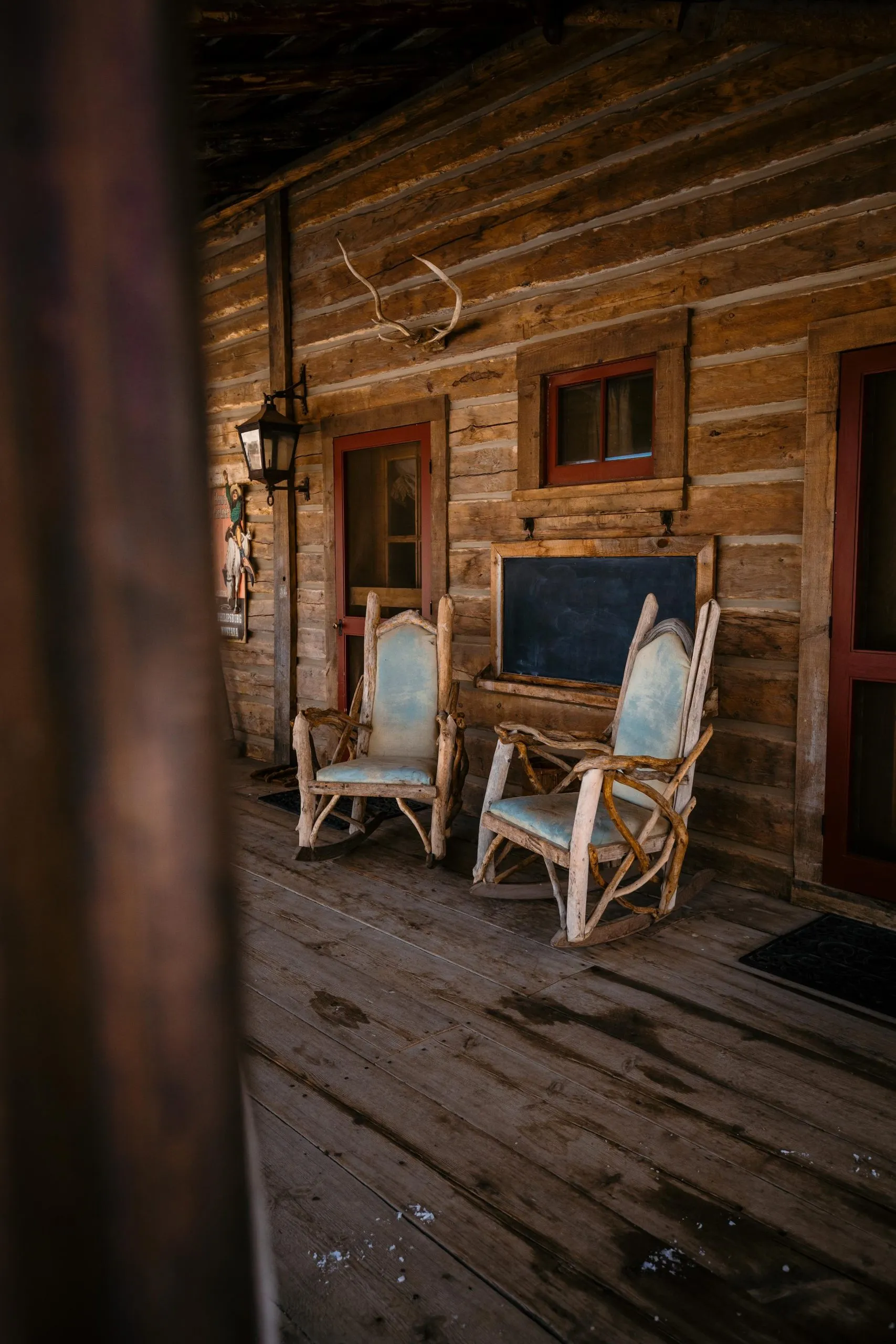 Two wood rocking chairs on an outdoor porch