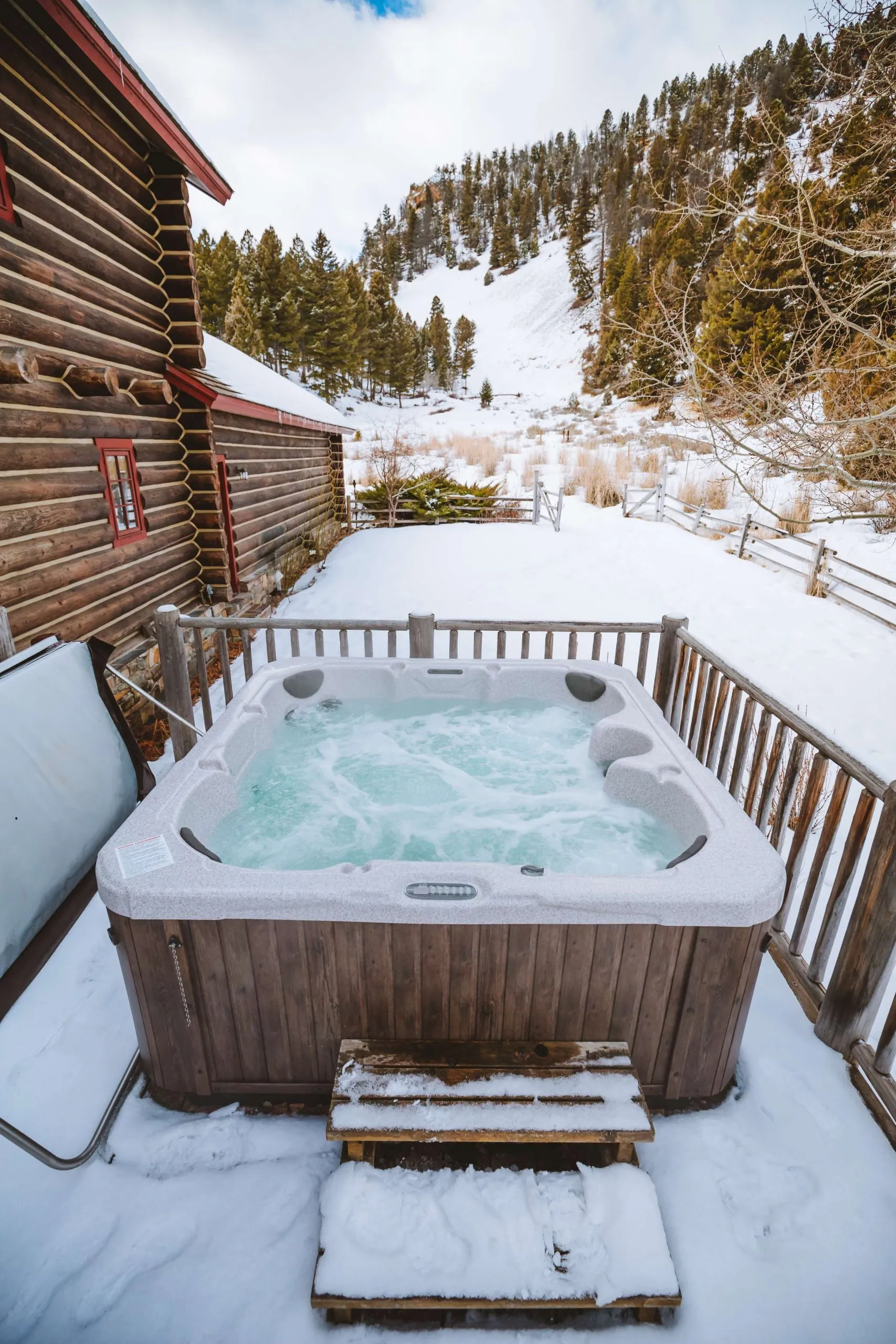 A running hot tub outside on a porch in the winter 