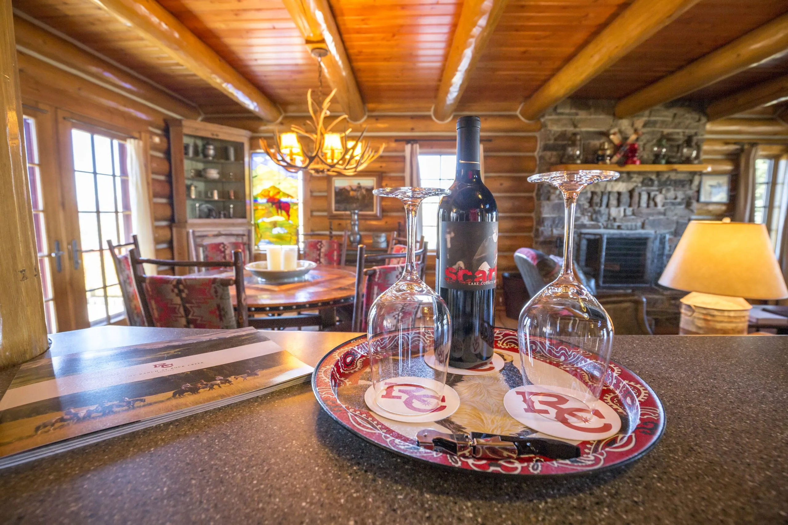 Cabin dining area with wine and glasses on the counter