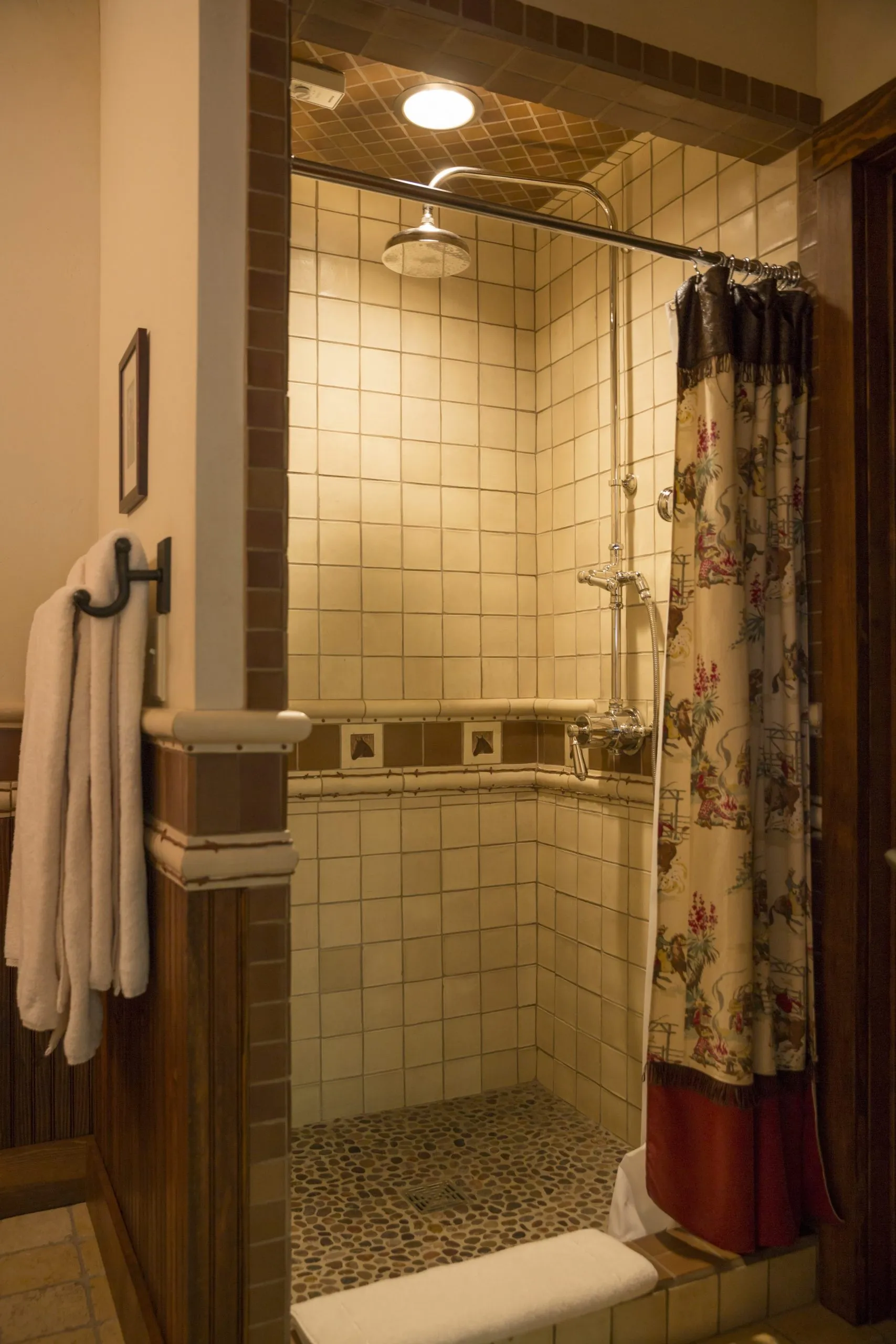 Tiled shower with a rainfall shower head and open curtain