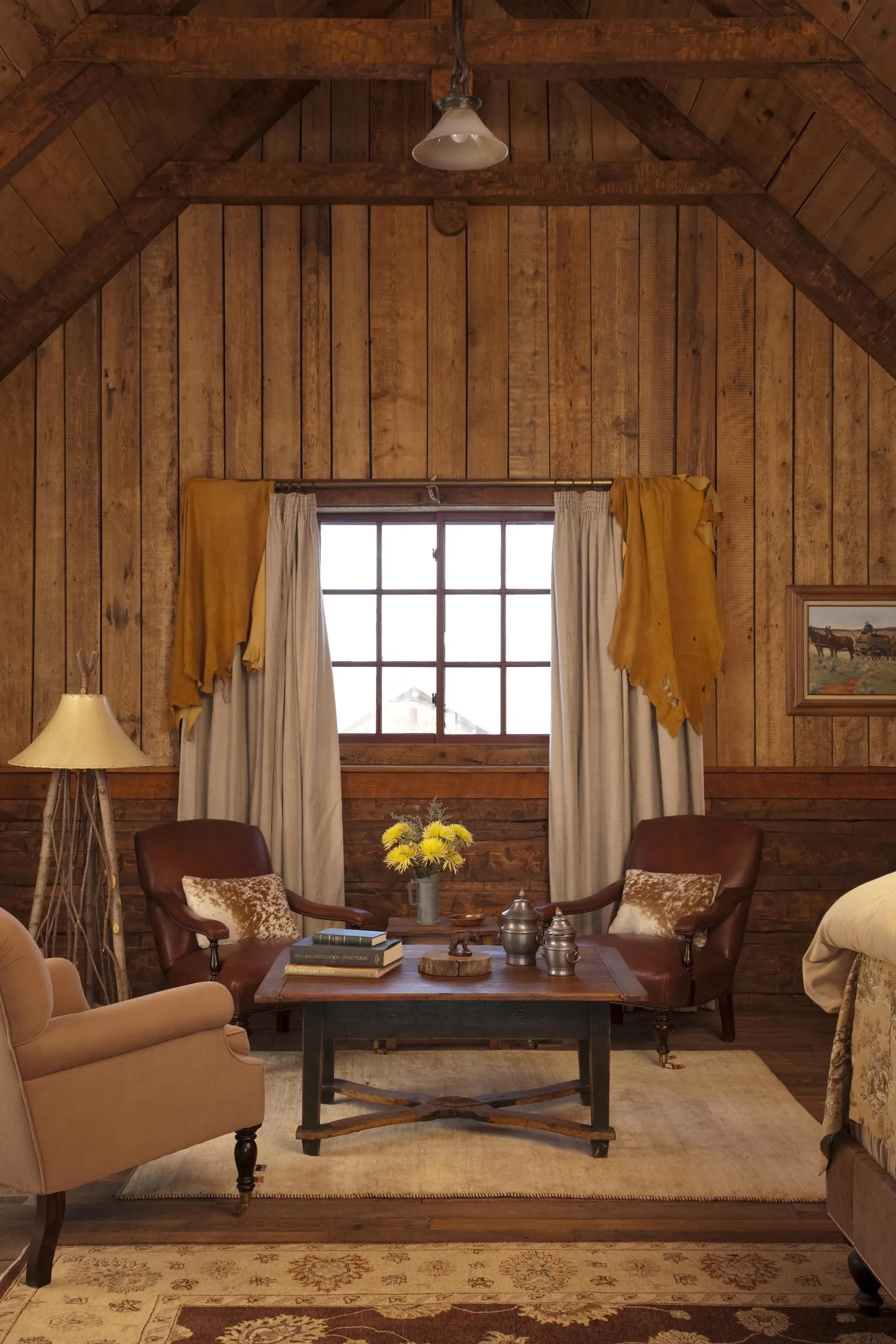 A log cabin living room with four chairs around a table