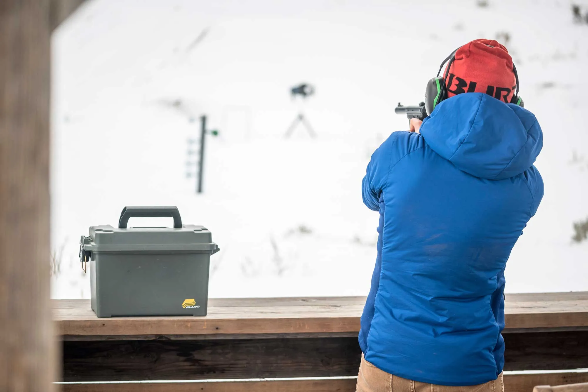 Man shooting target at gun range in the snow