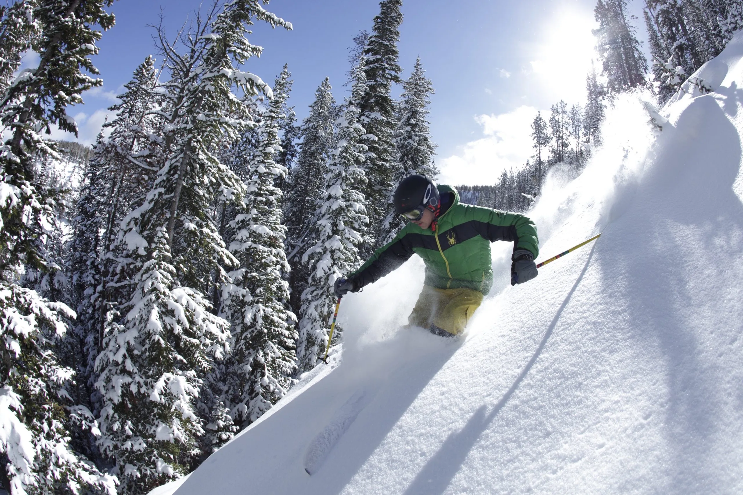 A skier skiing down a steep slope