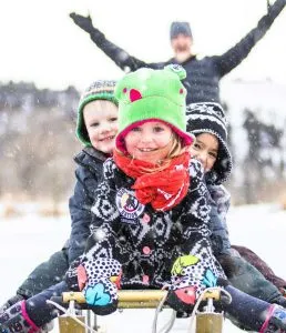 Kids sitting on sled having fun