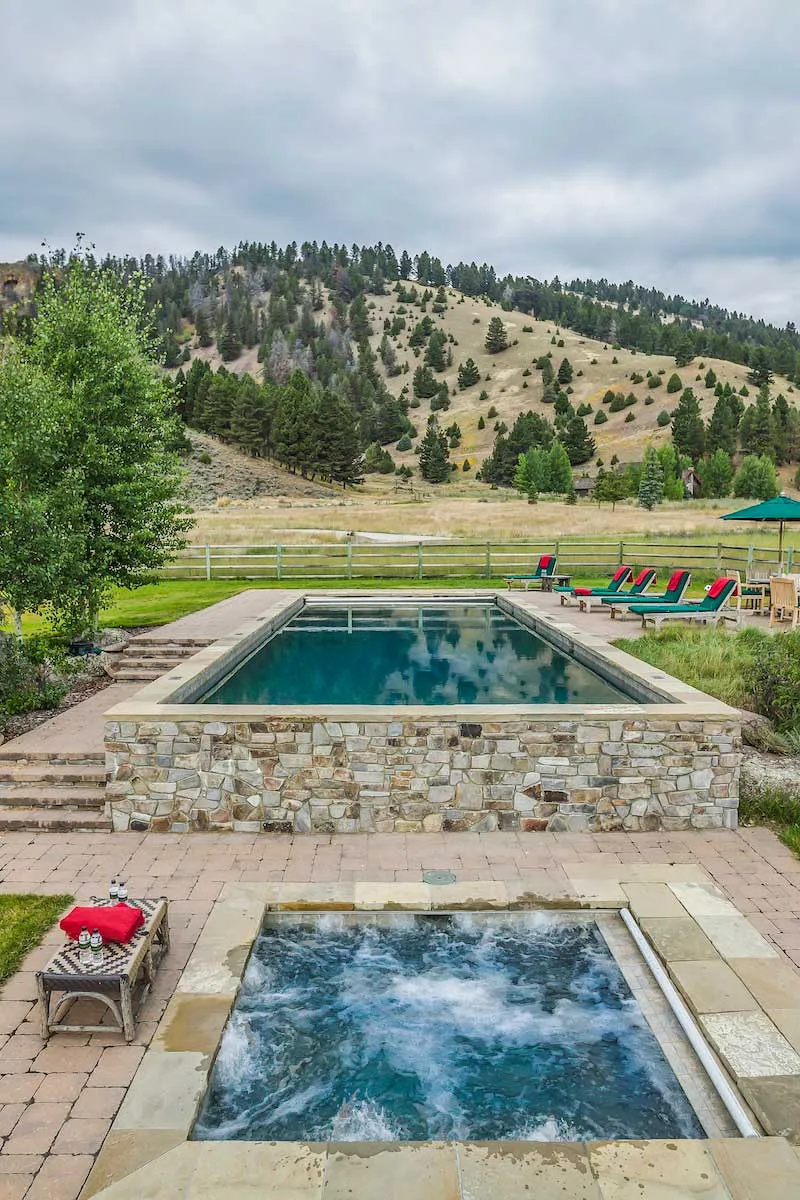 Pool and hot tub overlooking the ranch and beautiful mountains