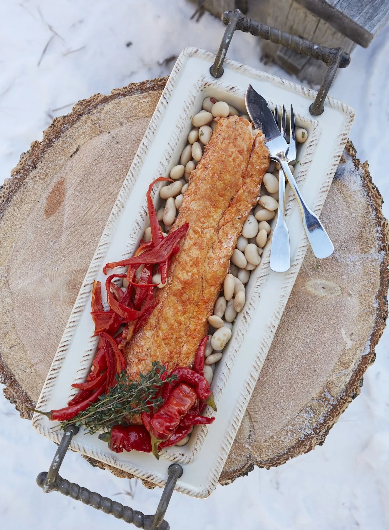 A serving plate of fish and beans