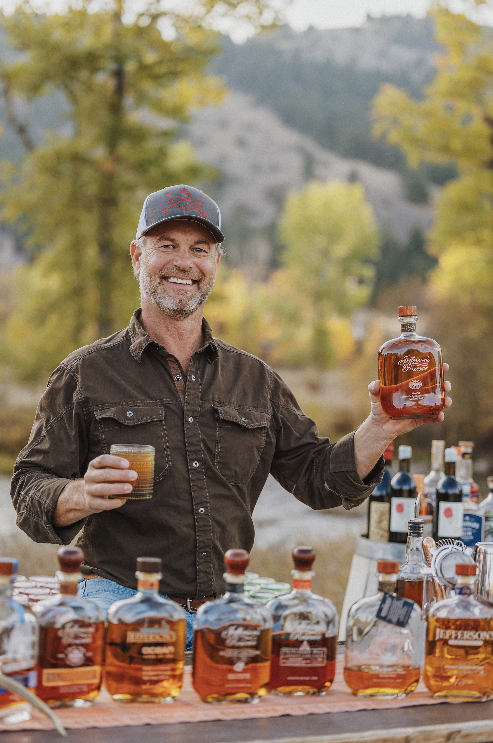 Trey Zoeller holding a bottle of Jefferson's Bourbon