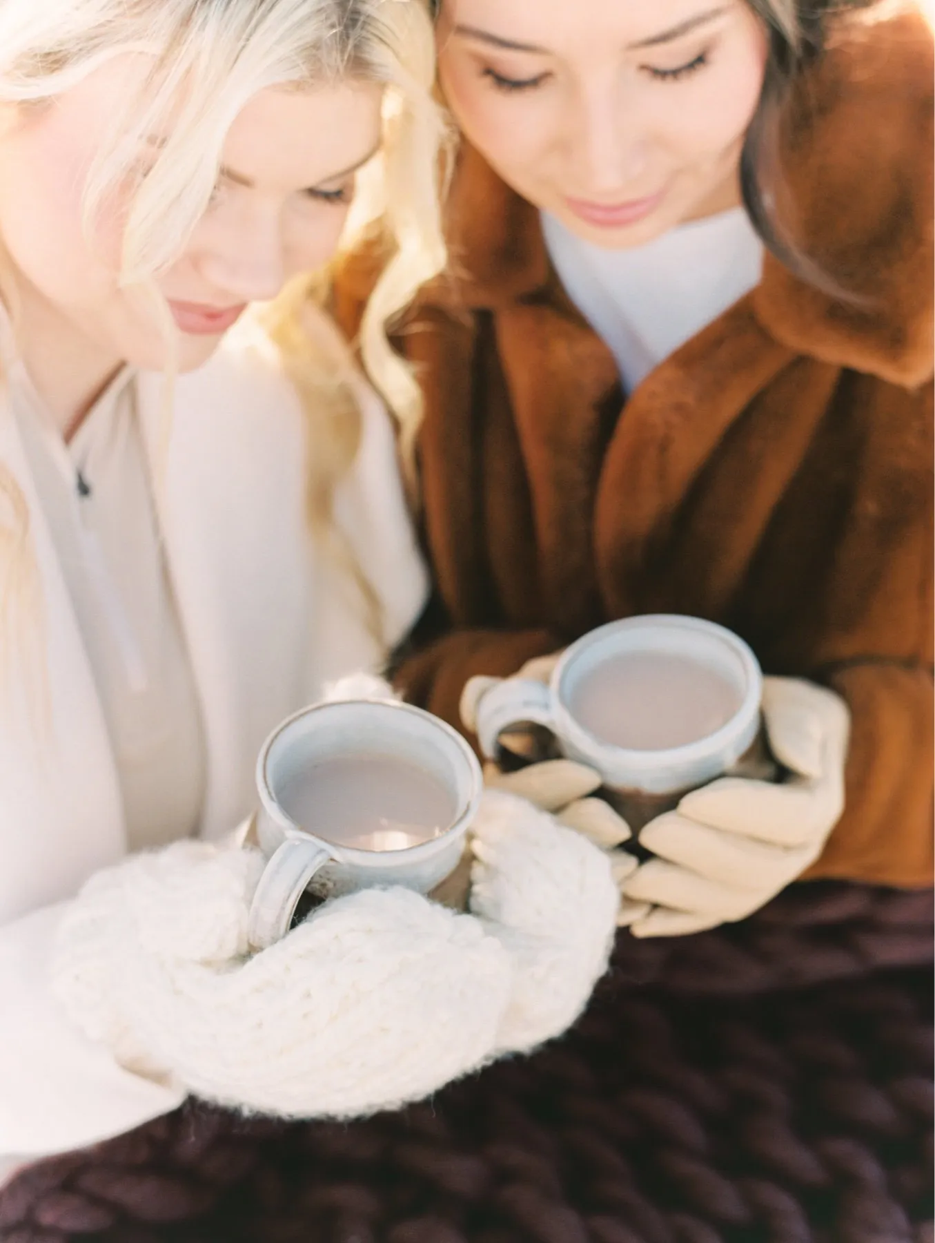 Two women holding mugs