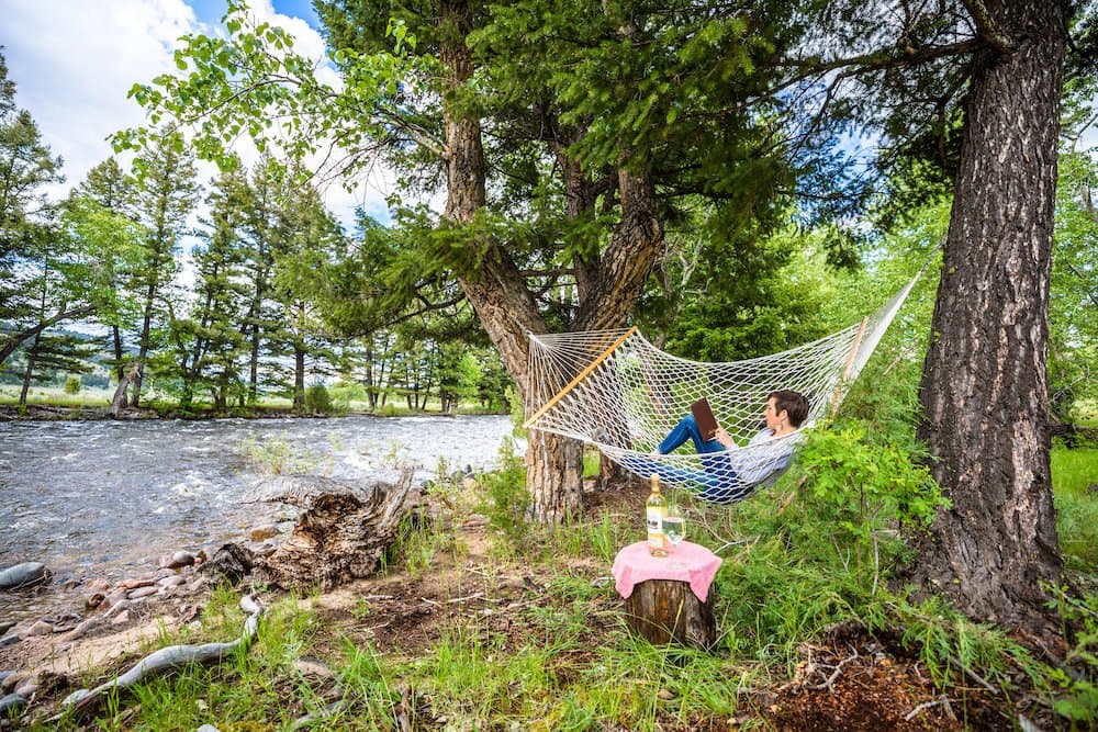Person reading a book and enjoying Respite on Rock Creek