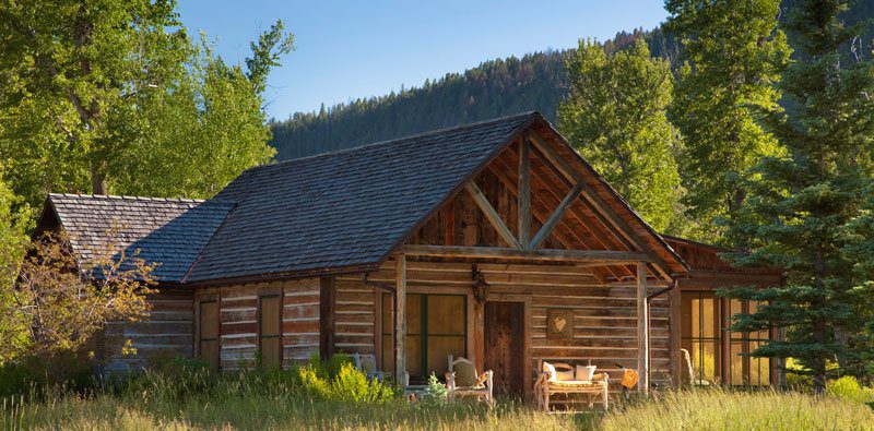 front view of a wood cabin with a nice blue sky