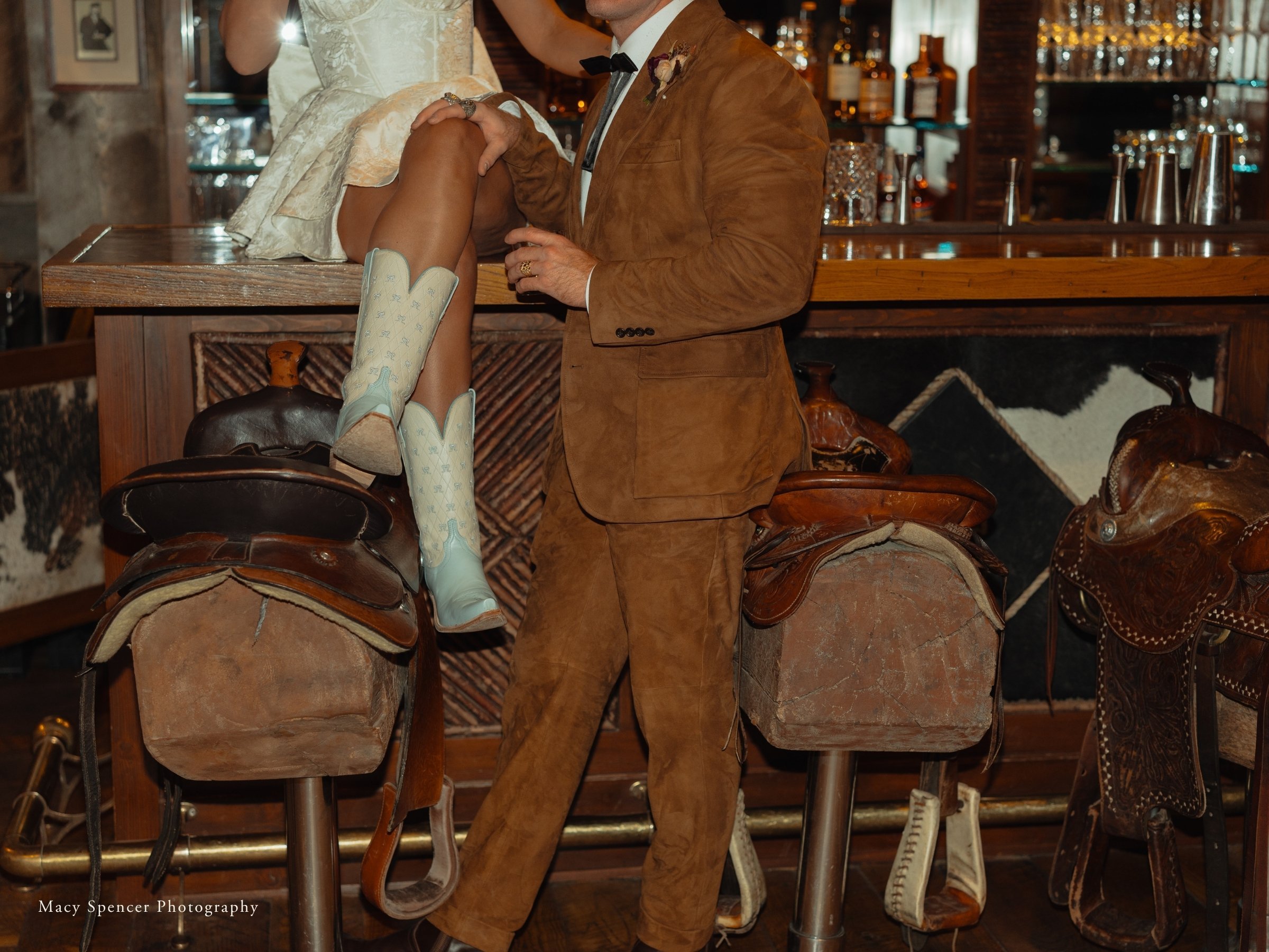 Wedding couple at the Silver Dollar Saloon for after party on the saddles.
